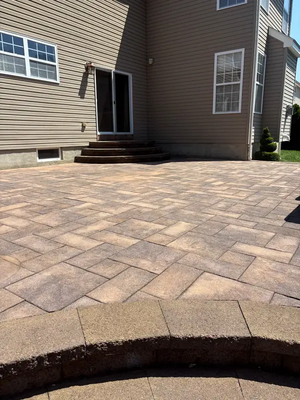 Dirty, stained paver patio before pressure washing in New Jersey