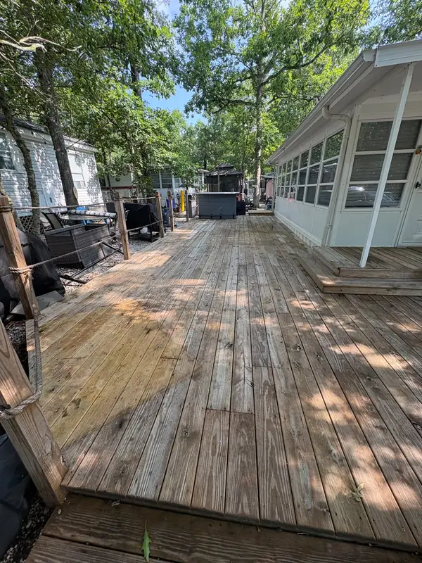 Weathered gray wood deck at a New Jersey home before pressure washing