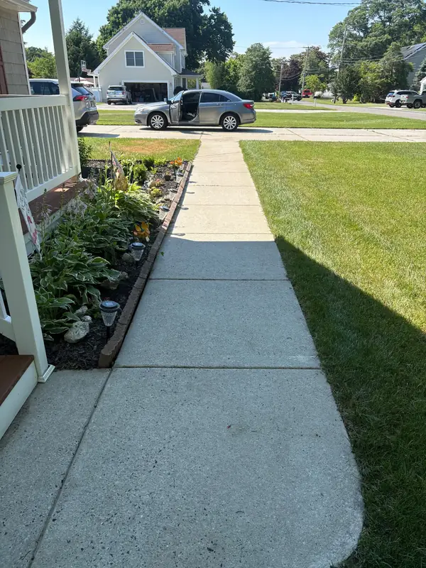 The same concrete walkway cleaned to an even, bright finish