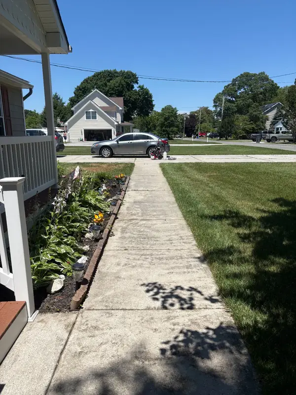 Stained concrete walkway before pressure washing