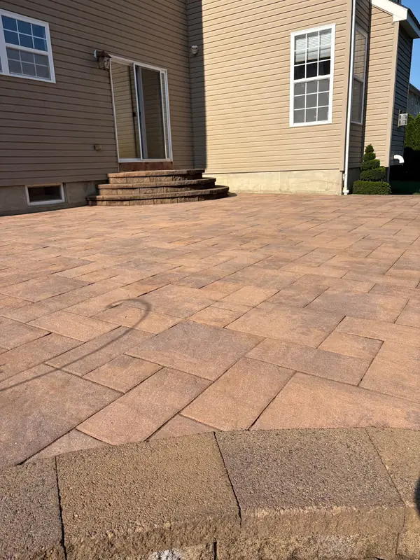 The same paver patio cleaned and brightened after pressure washing